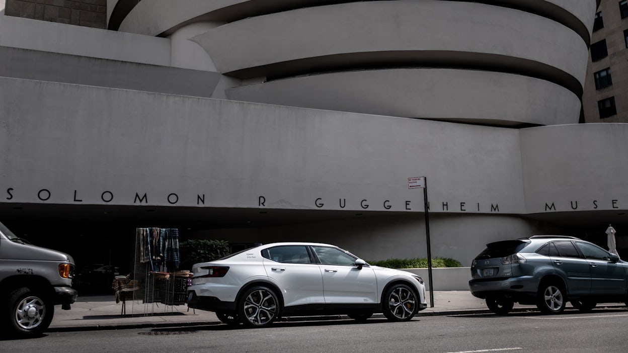 White Polestar 2 parked by the entrance to the Guggenheim museum.