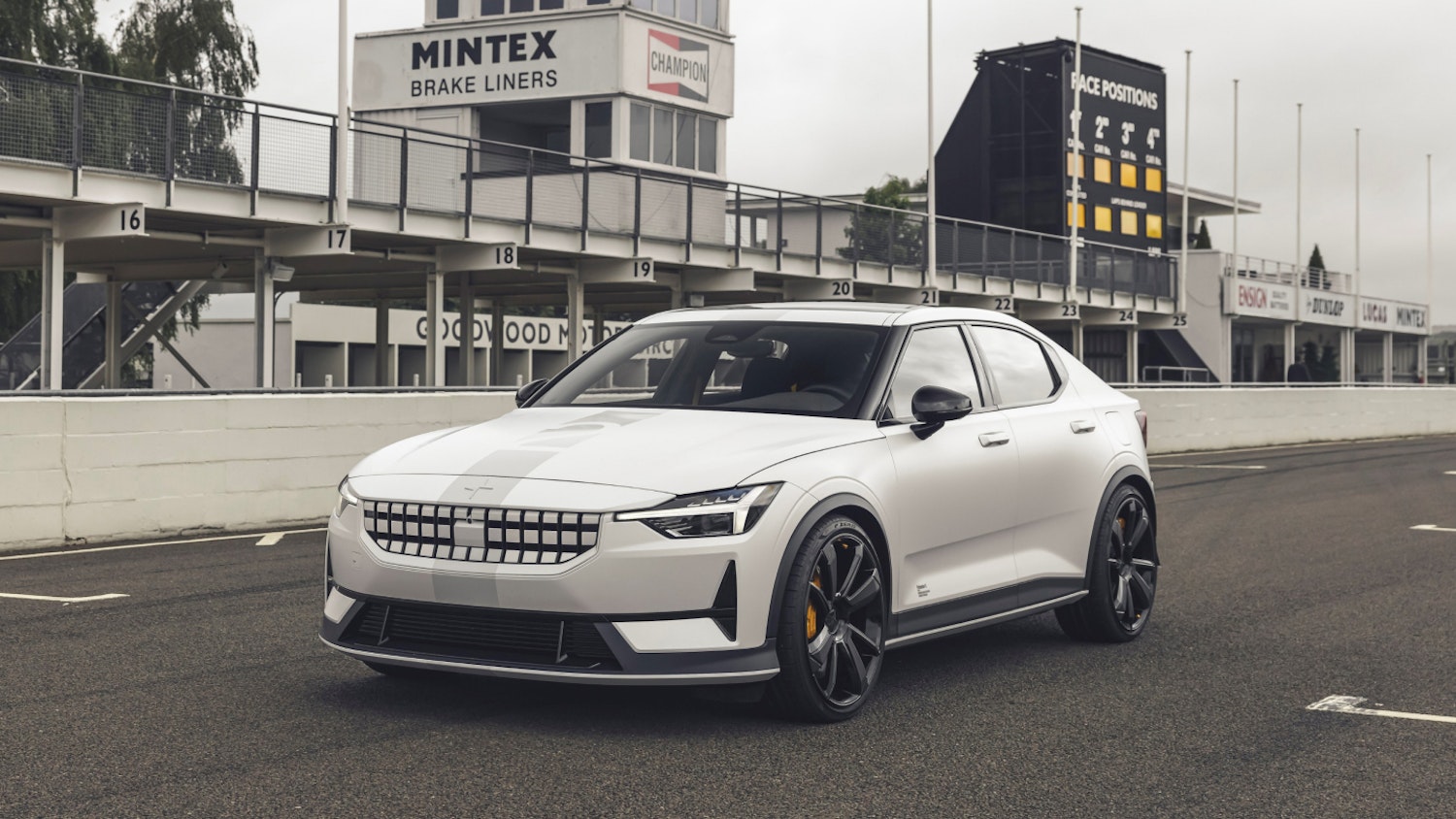 Polestar 2 BST edition 270 in colour Snow and race stripe adorned in pole position on a racing track