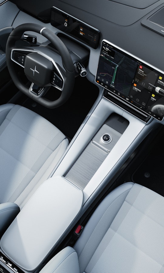 Polestar 4 interior with Tailored knit upholstery, focusing on the front 2 seats and centre display