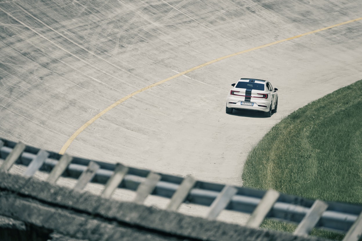 White Polestar 2 with black stripe across the car driving on the Monza race track.