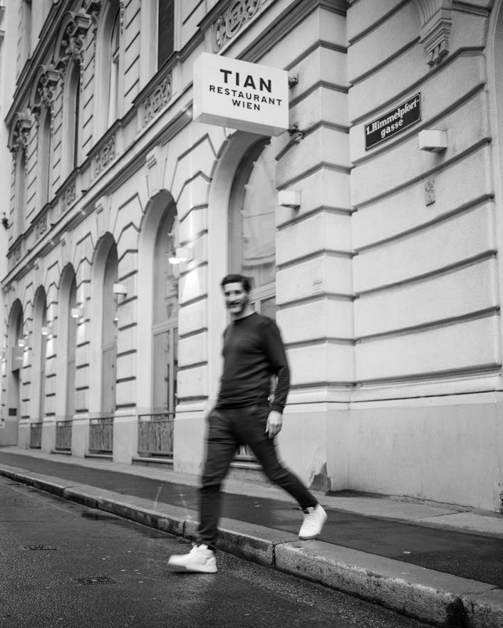 Paul Ivic walking outside his restaurant TIEN