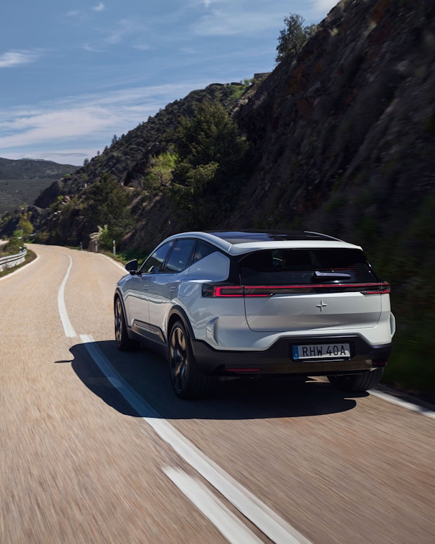 Polestar 3 in Snow color driving on a winding road in Spain