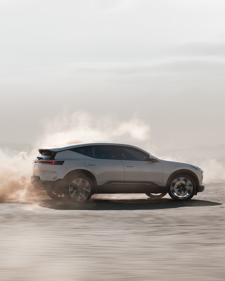 Side view of Polestar 3 driving on sand dunes