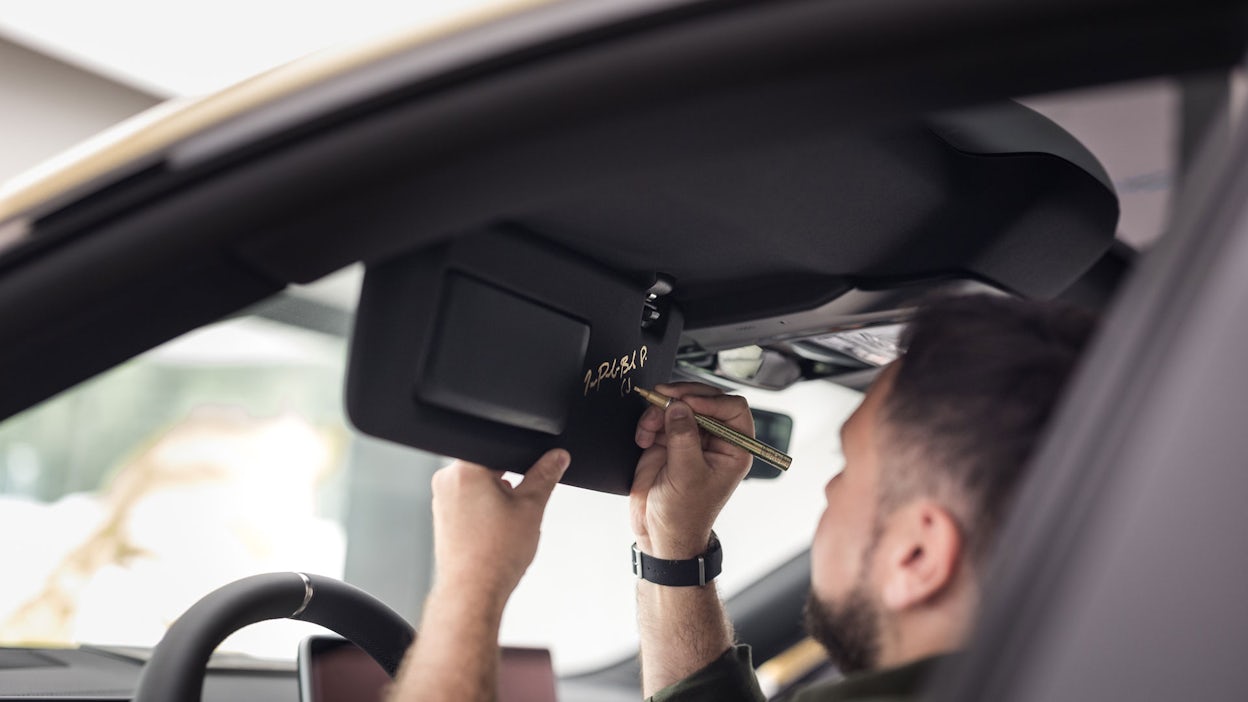 JP sitting in the driver's seat of a Polestar 4, signing his signature