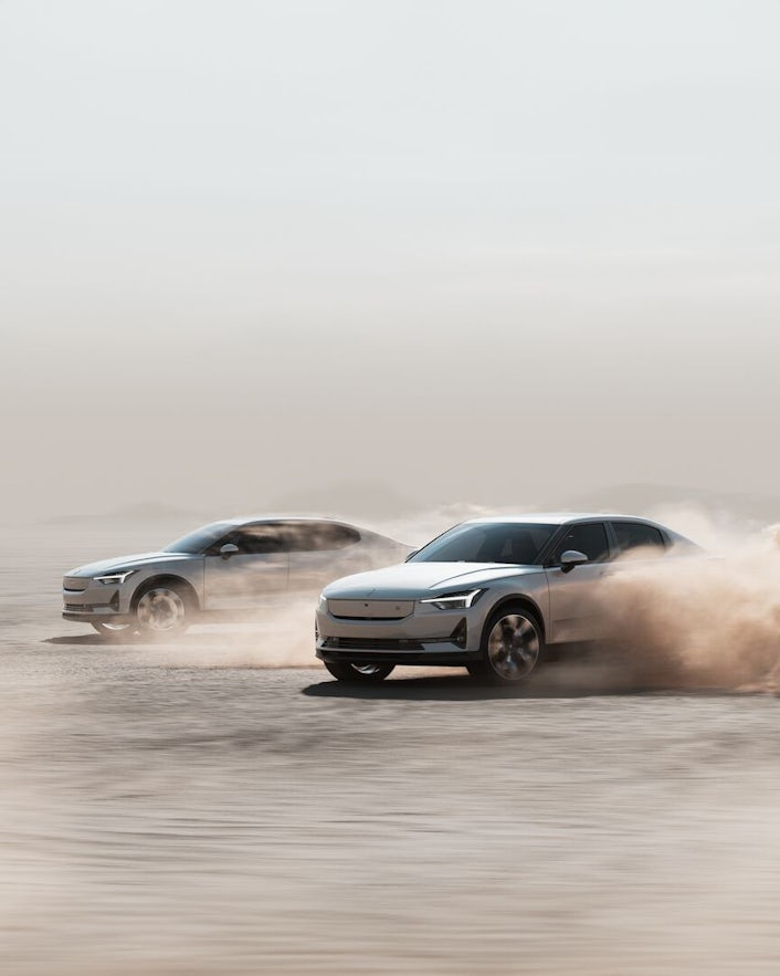 Two Polestar 2s driving in the deset