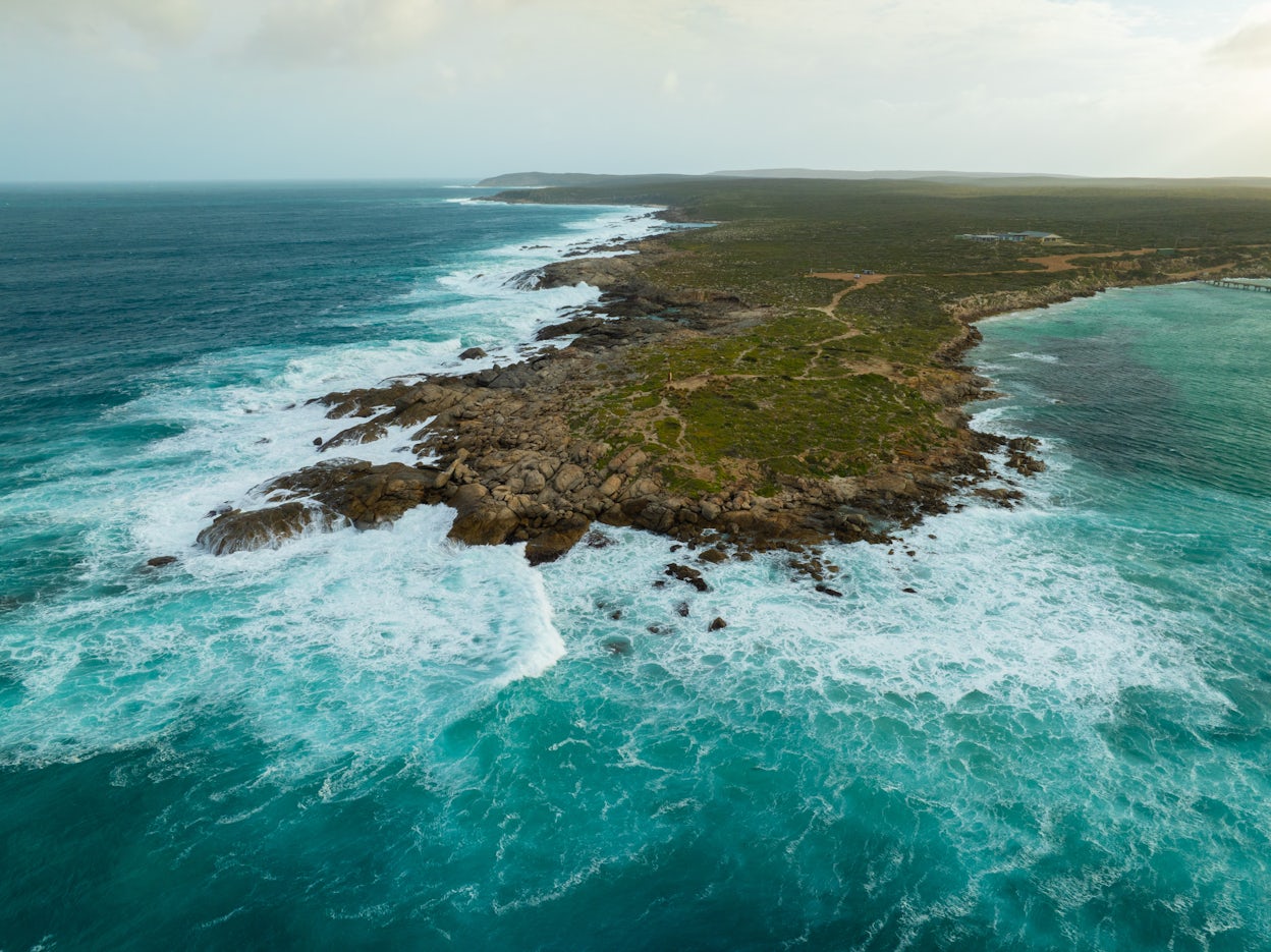 An aerial shot of Kangaroo Island's coastline from above the ocean.