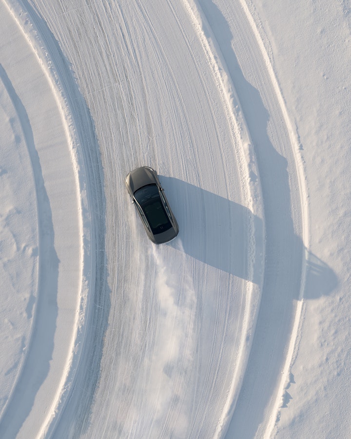 Polestar 2 sliding through a left-hand corner seen from above