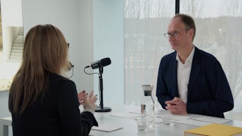 Two people sitting across a table talking