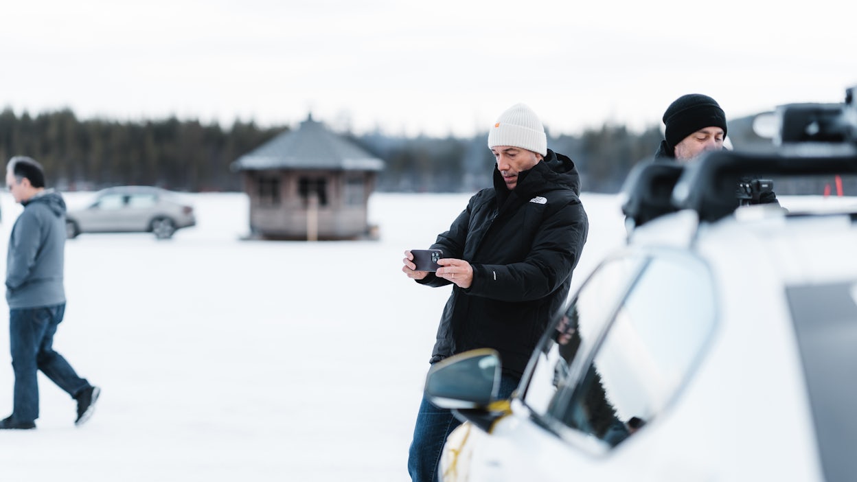 Man taking picture of something off camera