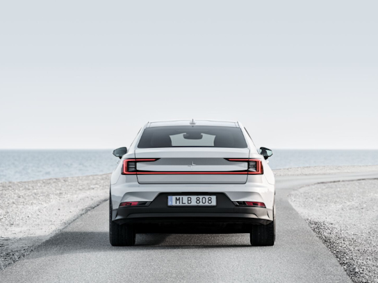 Rear view of Polestar 2 on a beach road